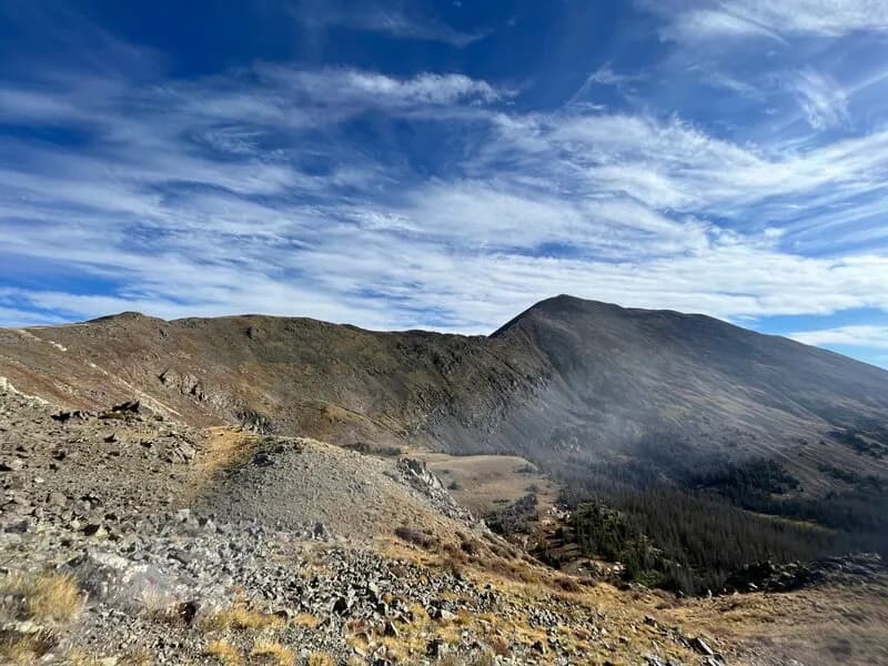 Walking Along The Long Ridgeline Toward The Summit